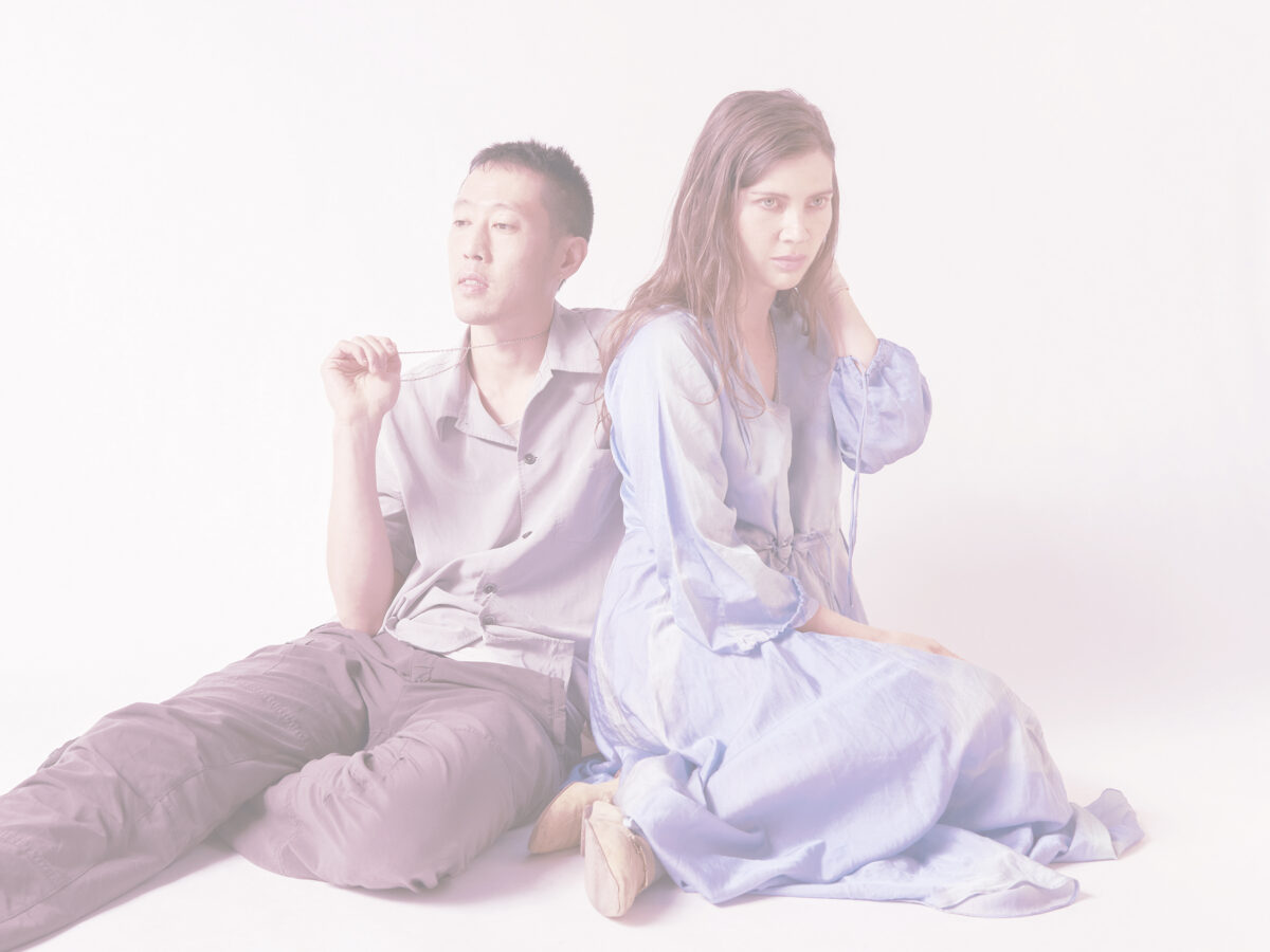 A women and a man sitting on the floor looking pensive and mysterious with soft filter