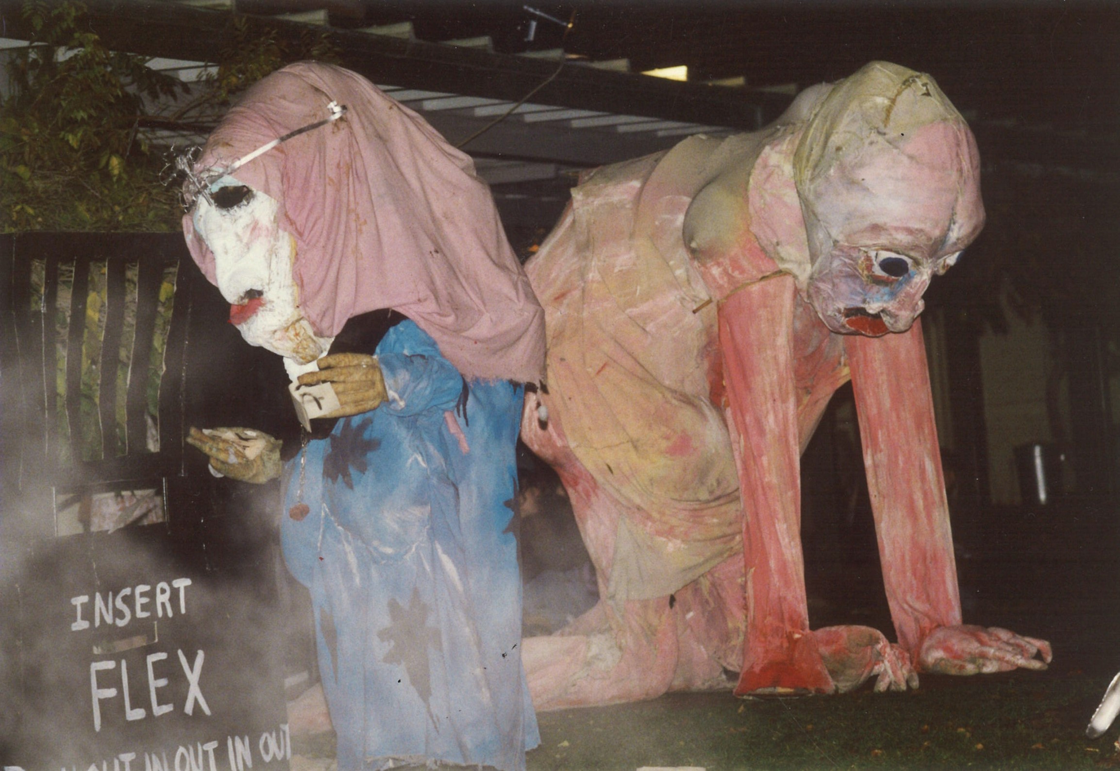 Two large paper mâché puppets are crudely painted in blue and red.