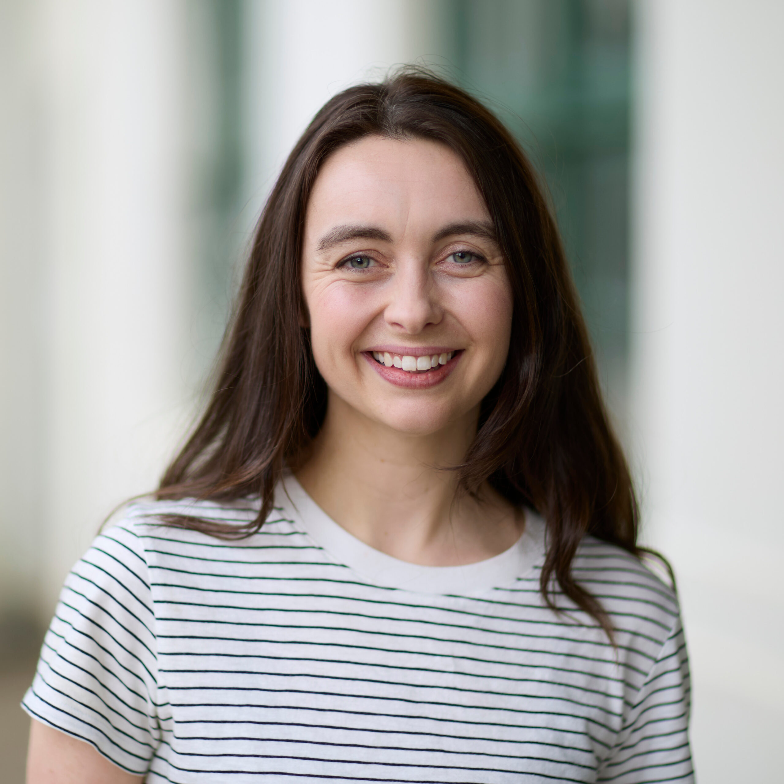 Portrait of Rebecca wearing a striped t-shirt.