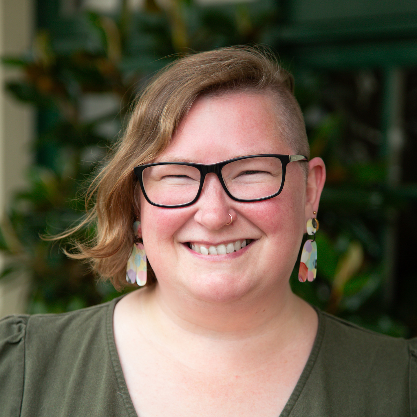 Portrait of Alison Malmberg wearing an olive green top.