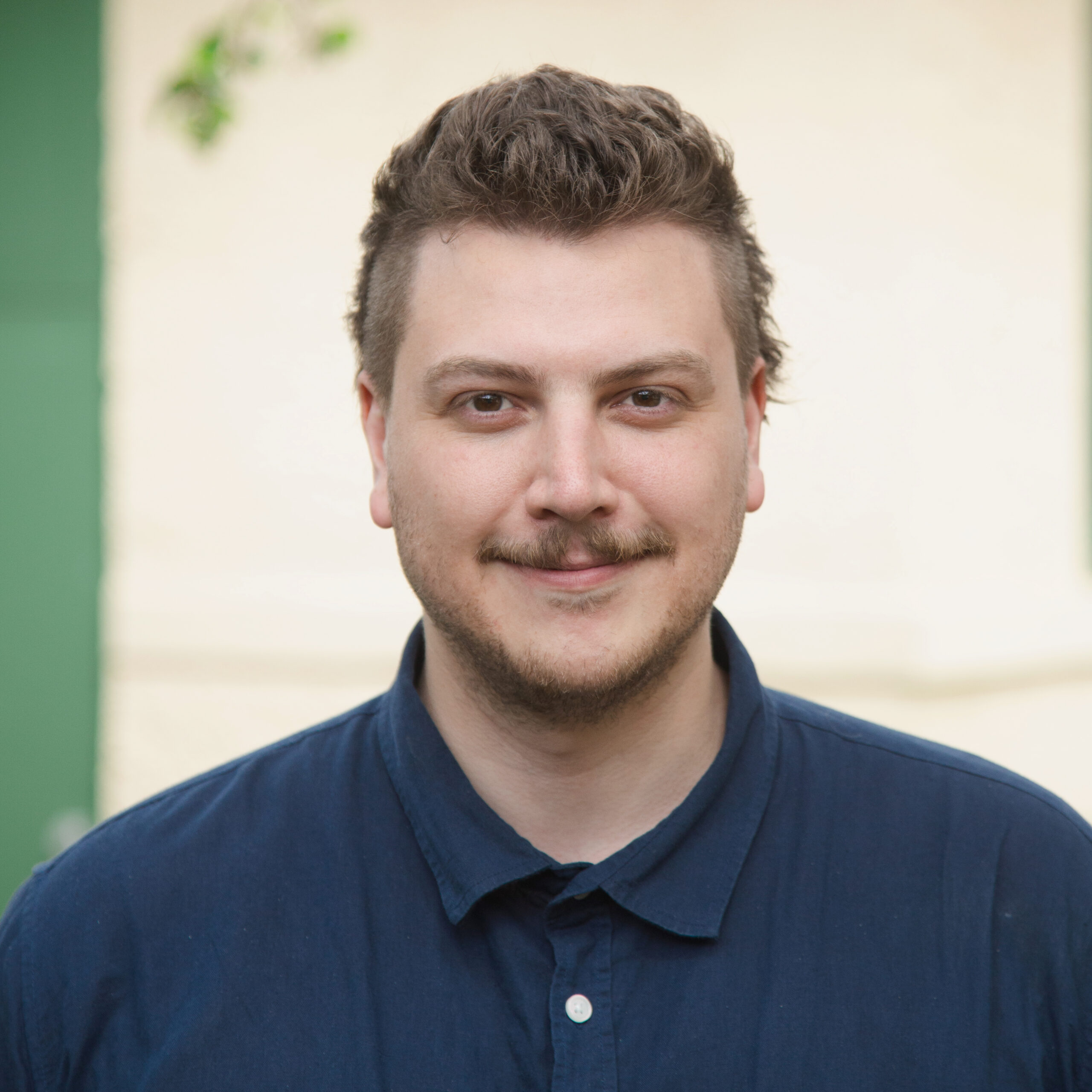 Portrait of Lachlan Johnson wearing a dark blue shirt.